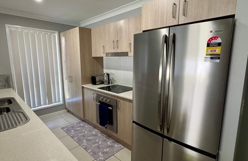 Coomera House | 4-BR Home close to beaches and attractions. Includes access to a pool, spa, gym