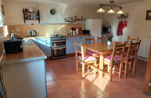 Lampeter Cottage | A cosy former horse stable with stone walls and old beams throughout
