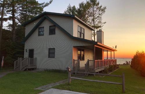 Onaway House | Black Lake sunset waterfront home 78' private sandy beach on prestine Black Lake