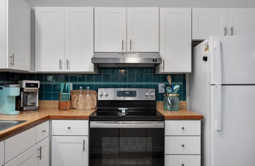 Colington Harbour House | Boho-chic Banks getaway with luxe interior, hot tub, AC, & W/D - dog friendly