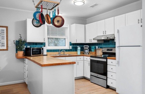 Colington Harbour House | Boho-chic Banks getaway with luxe interior, hot tub, AC, & W/D - dog friendly