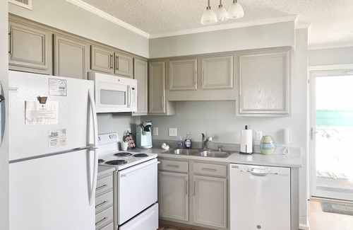 Carolina Beach Condo | ☀ Breezy, Open Condo, Steps from Beach and Boardwalk with Ocean Views & Pool ☀