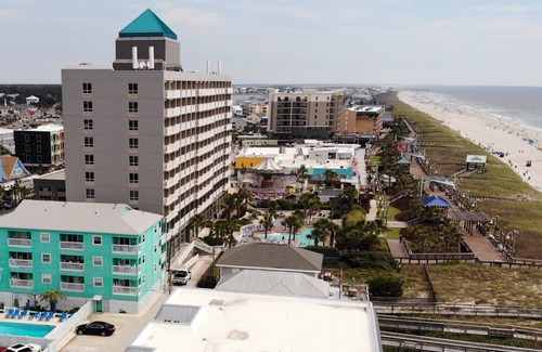Carolina Beach Condo | ☀ Breezy, Open Condo, Steps from Beach and Boardwalk with Ocean Views & Pool ☀