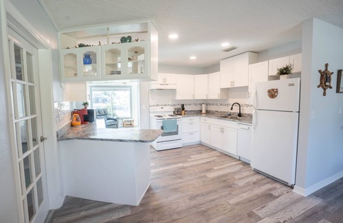Gulf Cove House | Bright Waterfront Home. Heated Pool. Short drive to Beach. Beautiful Sunsets.
