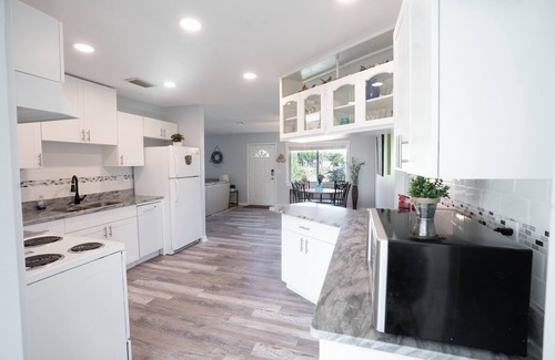 Gulf Cove House | Bright Waterfront Home. Heated Pool. Short drive to Beach. Beautiful Sunsets.