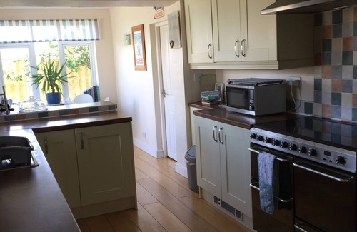 Caergeiliog House | Bungalow in Trearddur Bay, 4 min drive from beach & with open countryside views,