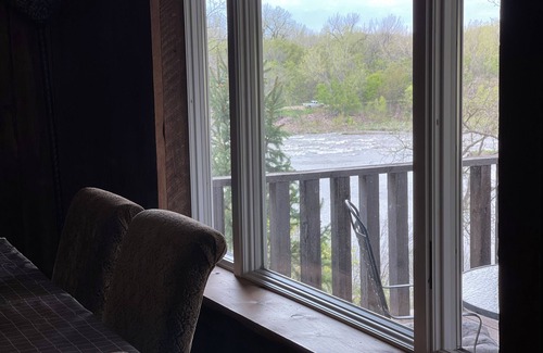 Larchwood House | Cabin on bluff of Big Sioux River with rushing waters of the Klondike Dam below.