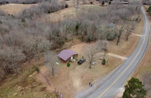Marshall House | Cabin with a tree house on a buffalo farm .