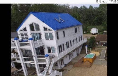 Alto House | Campau Lake 1st level · Lake level hot tub spa, TIki bar, lakefront