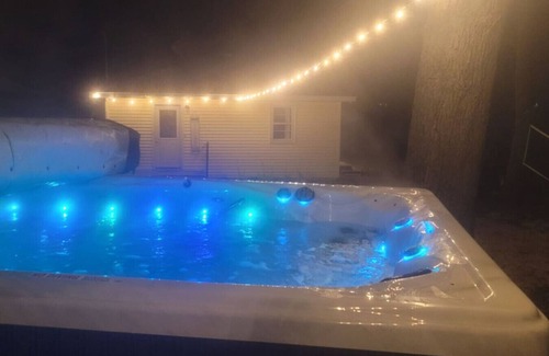 Alto House | Campau Lake Sunshine, hot swim spa tub, King Bed lakefront