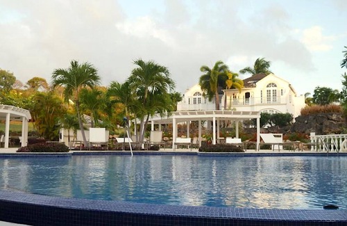 Merlin Bay Apartment | Caribbean Queen is located on the exclusive Royal Westmoreland Golf Resort