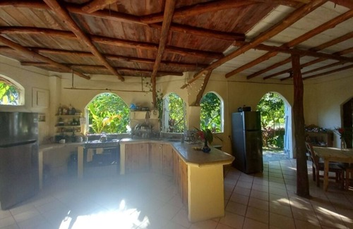 Buenos Aires Ski Chalet | Chalet with jungle view deck on a river in lively Santa Teresa's surf town