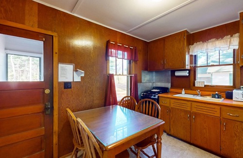 Manitowish Waters Cabin | Charming waterfront cottage with shared firepit, canoe, paddlebaot & docks