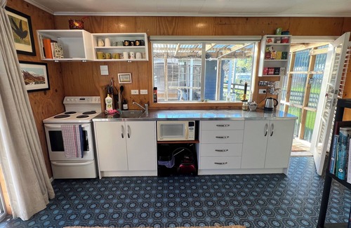 Kawhia Cottage | Cosy Aotea Cottage with water views, a gentle stroll to the beach. Pet Friendly!