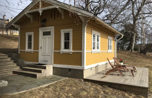 Boo House | Cottage with sunny wooden deck by water. Rowing boat included.