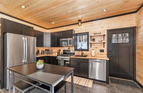 Norwich House | Cozy 2BR/1BA cabin for 6. Fireplace, outdoor fire pit, hot tub, and soaking tub.
