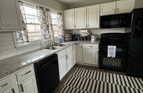 Wichita House | Cozy house in quiet neighborhood with hot tub, fire pit, and arcade games!