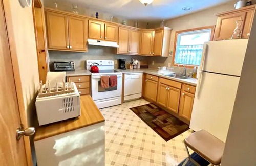 Swan Lake Cottage | Cozy lakeside cottage with modern furniture on a quiet street.