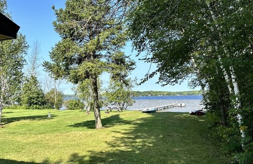 Gould City Cottage | Cozy log cabin on South Manistique Lake with 100 feet of sandy beach, sunsets