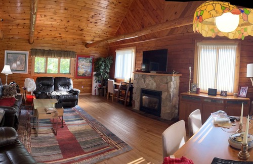 Gould City Cottage | Cozy log cabin on South Manistique Lake with 100 feet of sandy beach, sunsets