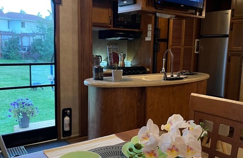 Leduc County House | Flex RV Travel trailer parked on a beautiful 4 acre lot, overseeing forest land.