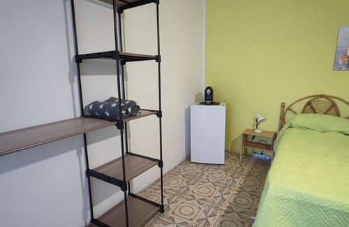 Stromboli Villa | Green room with 4 beds, bathroom and patio with equipped kitchen