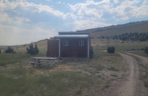 Manhattan Cabin | GRIZZLY ROCK RANCH Rustic Tiny Log Cabin Glamping and Horseback Riding Available