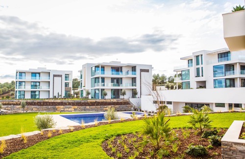 Vila Nova De Cacela Apartment | Heated pool, lush gardens, and air conditioning at Monte Rei.