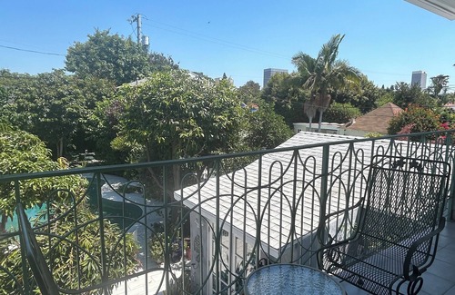 Mid City House | Historic Hollywood Haven in LA with Lush Garden, Balconies & Star-Studded Past