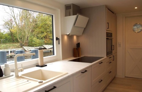 Otterndorf Boat Rental | Houseboat with hot tub, sauna, wood-burning stove, air conditioning, lounge, sun deck and garden with dinghy directly behind the dike in Otterndorf