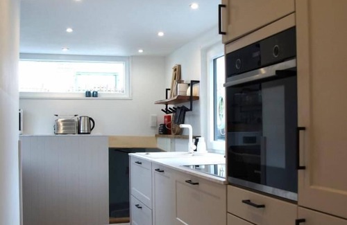 Otterndorf Boat Rental | Houseboat with hot tub, sauna, wood-burning stove, air conditioning, lounge, sun deck and garden with dinghy directly behind the dike in Otterndorf