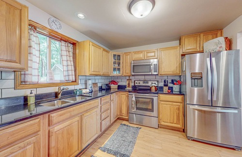 Arbor Vitae House | Lakefront home with large patio, fire pit, W/D & WIFI