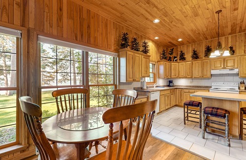 Manitowish Waters Condo | Lakefront resort retreat with screened porch, fireplace, pool, marina, & dining