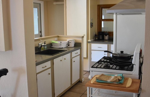 North Berkeley House | Large bedroom, bathroom & tenant kitchen, with lounge area and patio