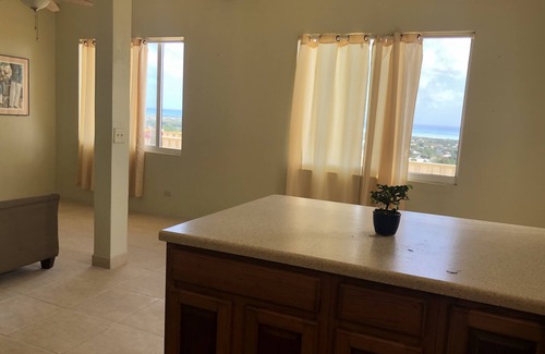 Estate Whim House | Large hillside one bedroom apartment with a sea view.