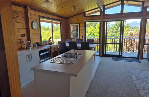 New Plymouth House | Lockwood holiday house, nestled among lush trees.