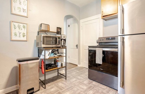 Indianapolis House | Lovely homey pad near Irvington with huge sofa, electric fireplace & porch swing