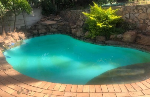 Randpark Ridge House | Lovely Studio Apartment sitting on a lovely acreage with natural man made rocks.