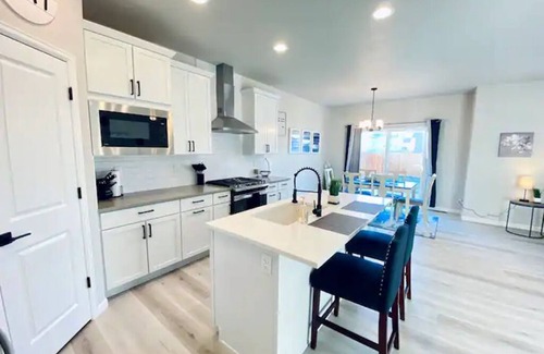 Milliken House | Modern home with a large fenced yard, and garage access