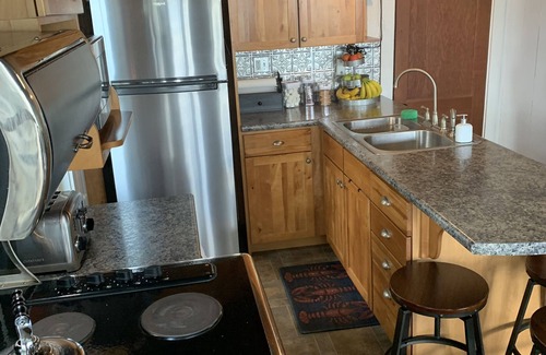 Oakland Cottage | Modern Lakefront Camp on East Pond - cozy fire pit, 3 kayaks, canoe