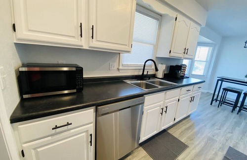 Kansas City House | Modern Oasis Near the Legends - Spacious home with games, patio, deck and more!