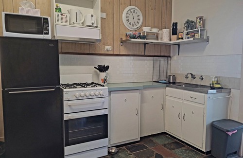 Brownlow Ki Apartment | Nestled behind the low hanging branches is this cute and cozy one bedroom unit