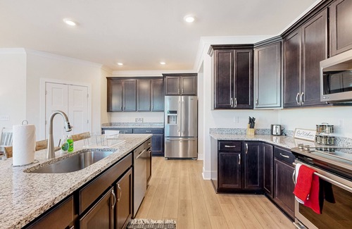 Seaford House | Newly built riverfront home with dock, kayaks, basketball court, & game room