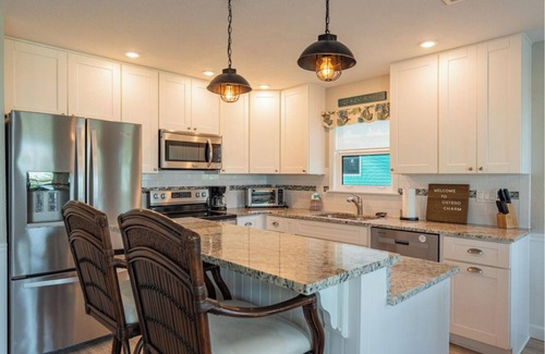 Fort Myers Beach House | Ostego Charm: Open floor plan, pool, porch, lush landscape—walk-able to the Beach!