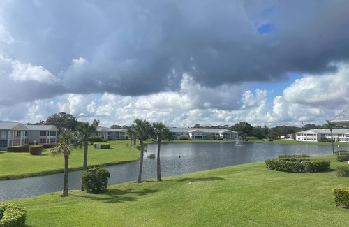 Florida Ridge Condo | Panoramic lake & fountain views from this light & bright condo.