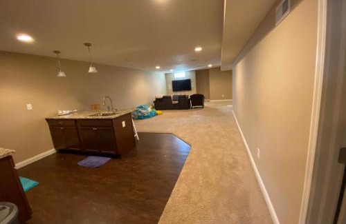 Maxwell House | Private basement bedroom with private bathroom, kitchen, and living room with large screen television