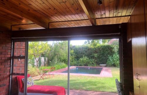 Die Boord House | Retro Red Stone Villa with pool & lush garden