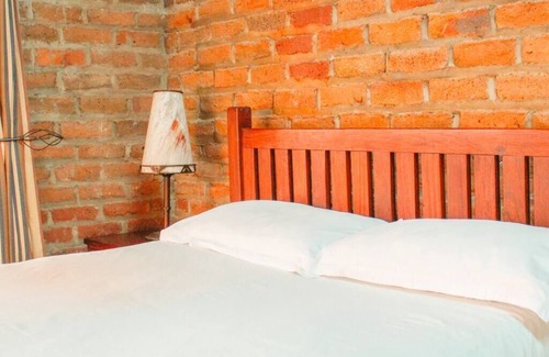 Nyanga Cabin | Rustic stone walls with modern conveniences in an African setting.