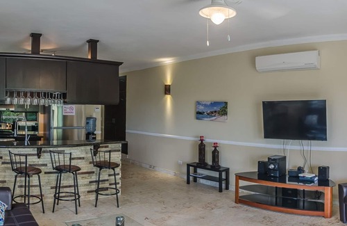 El Batey Apartment | Sea-views central condo with pool, BBQ. Guest-friendly, near sandy beach!
