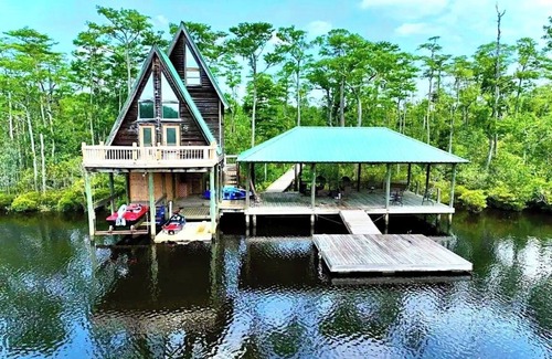 Satsuma Cabin | Secluded cabin on the water with jetski, hottub & kayak! Pets OK & early checkin